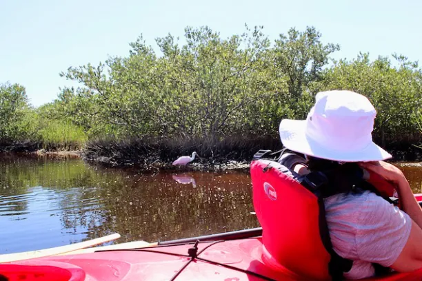 a woman sitting on a boat in the water