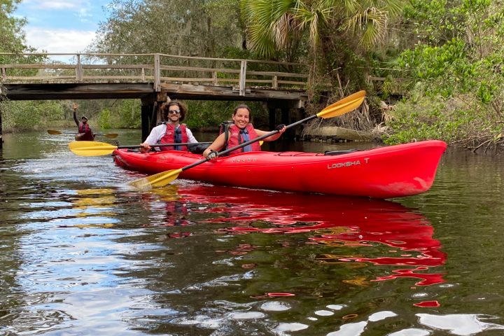 a group of people in a small boat in a body of water