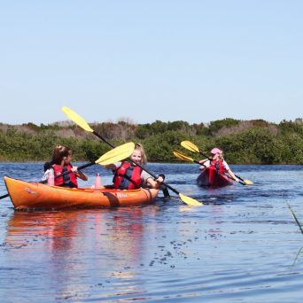 a group of people in a small boat in a body of water