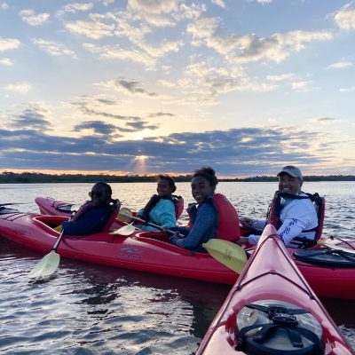 a group of people in a boat on a body of water