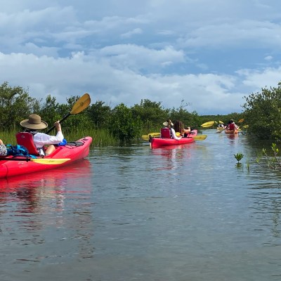 a group of people in a small boat in a body of water